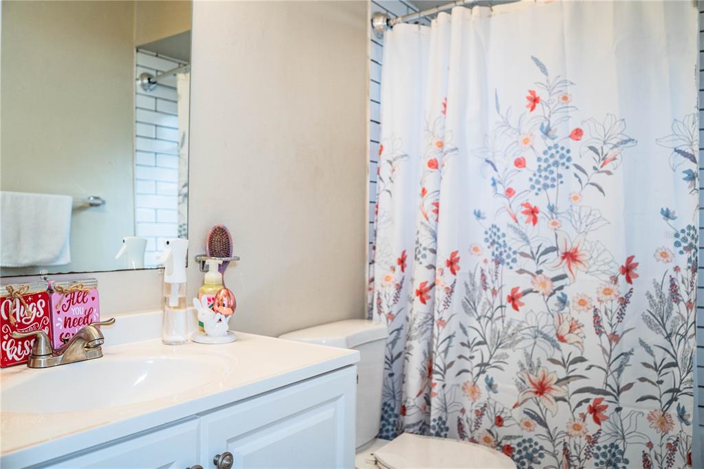 207 24th Court Southwest Winter Haven, FL 33880 - Photo 35 of 75 a bathroom with a sink vanity mirror and toilet