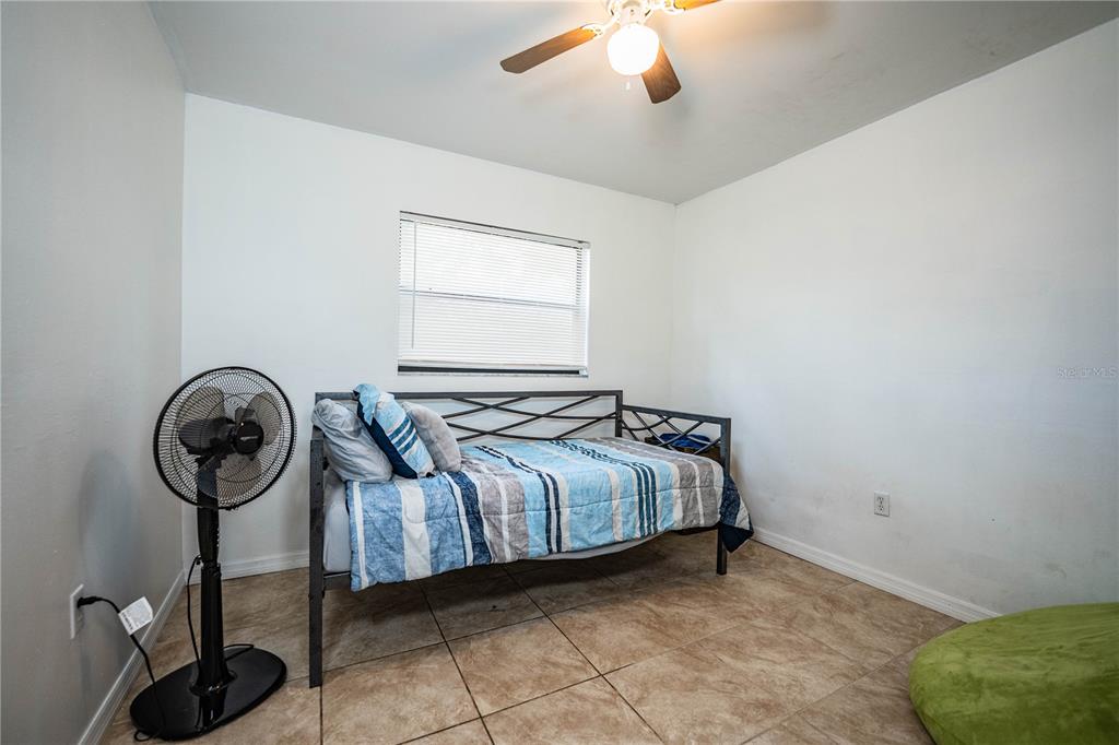 207 24th Court Southwest Winter Haven, FL 33880 - Photo 37 of 75 a bedroom with a bed and a chandelier