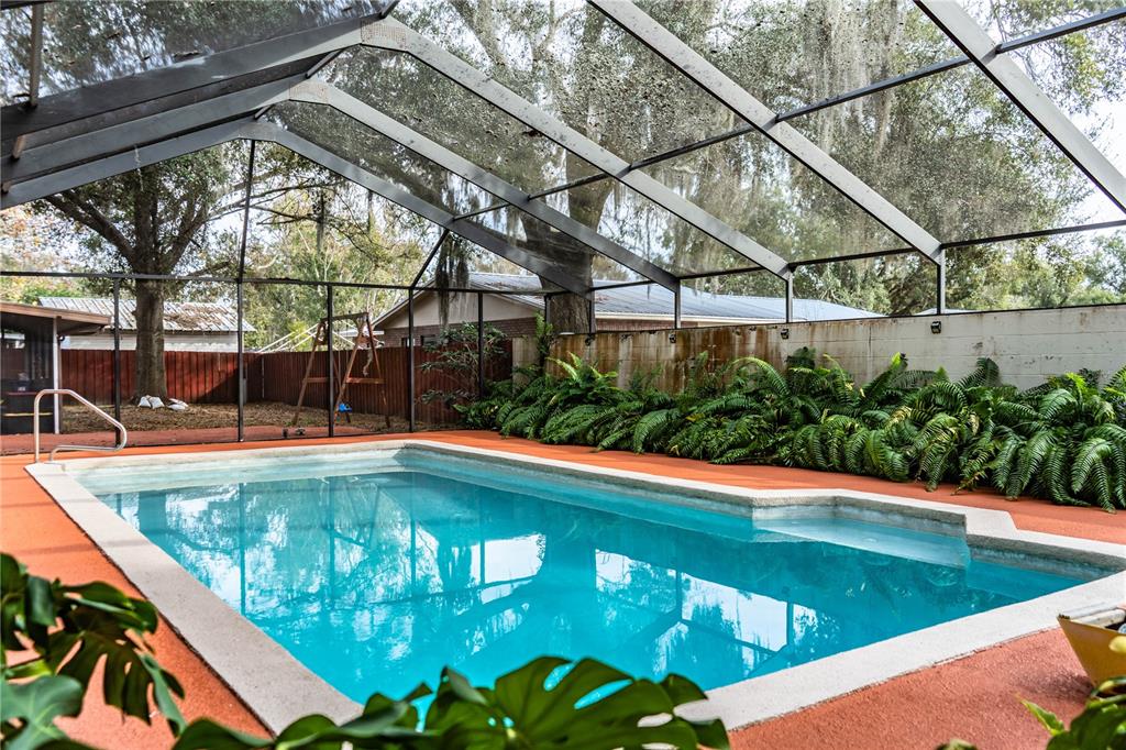 207 24th Court Southwest Winter Haven, FL 33880 - Photo 46 of 75 a view of a swimming pool with a patio and a yard