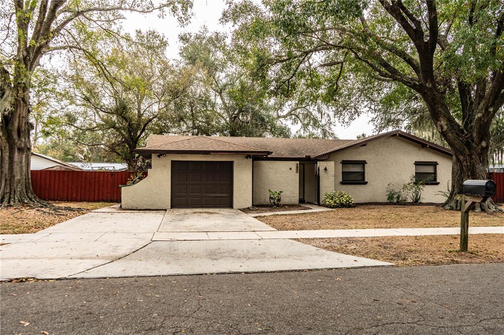 207 24th Court Southwest Winter Haven, FL 33880 - Photo 70 of 75 a white house that has a tree in front of it
