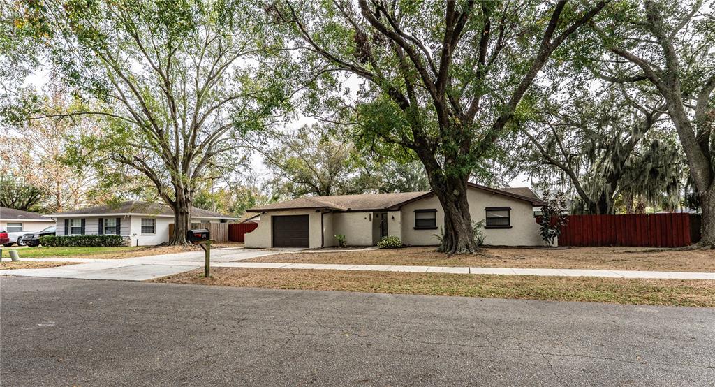 207 24th Court Southwest Winter Haven, FL 33880 - Photo 73 of 75 a front view of a building with trees and cars