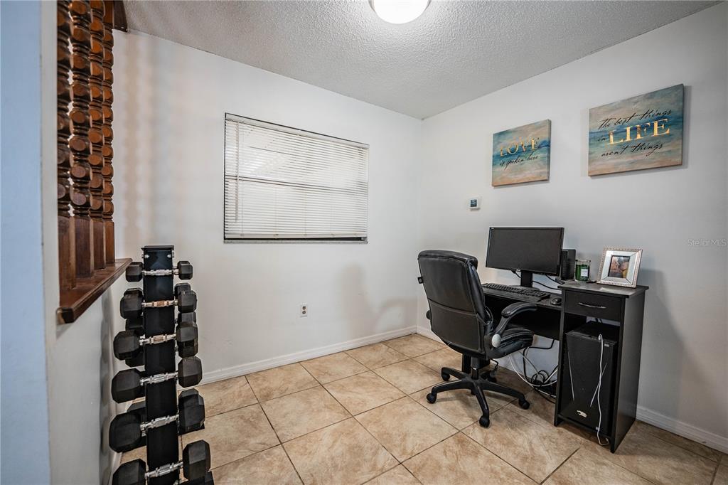 207 24th Court Southwest Winter Haven, FL 33880 - Photo 8 of 75 a view of a workspace with furniture and a window