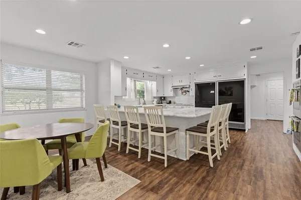 a dining room with furniture and wooden floor