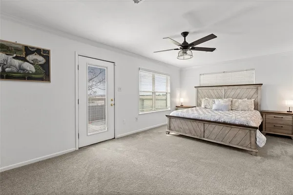 a spacious bedroom with a bed and painting on the wall