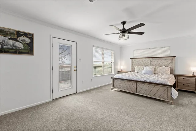 a spacious bedroom with a bed and painting on the wall