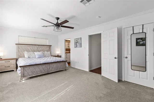 a bedroom with a bed and a ceiling fan
