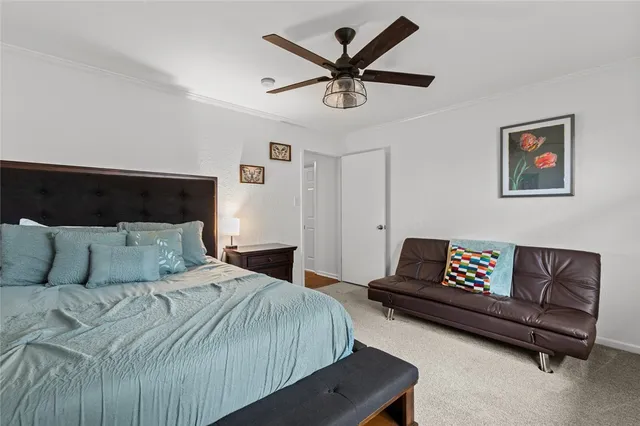 a bedroom with a bed and a couch