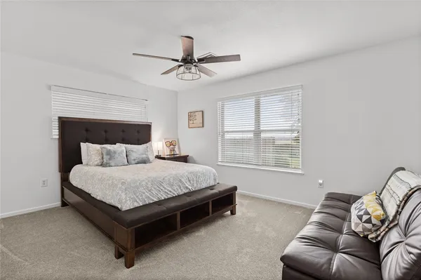a spacious bedroom with a bed and window