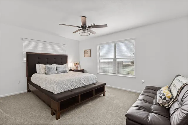 a spacious bedroom with a bed and window