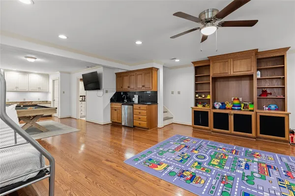 a living room with stainless steel appliances kitchen island furniture and a kitchen view