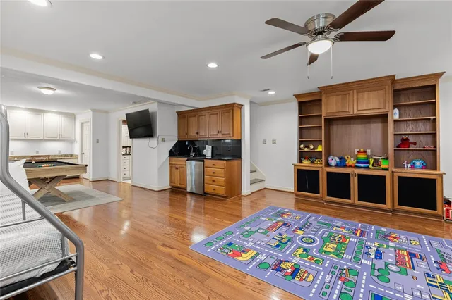 a living room with stainless steel appliances kitchen island furniture and a kitchen view