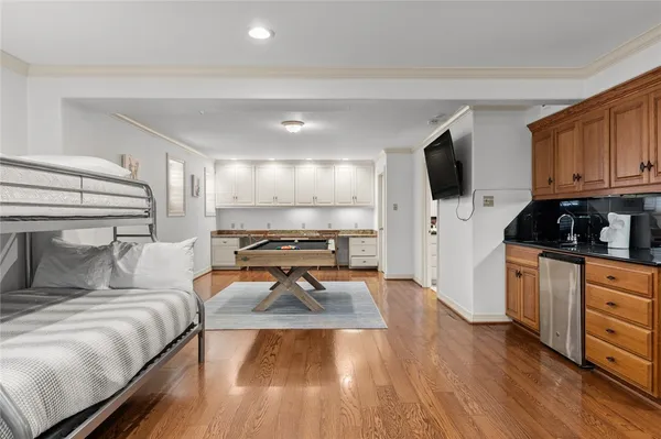 a bedroom with furniture and a flat screen tv