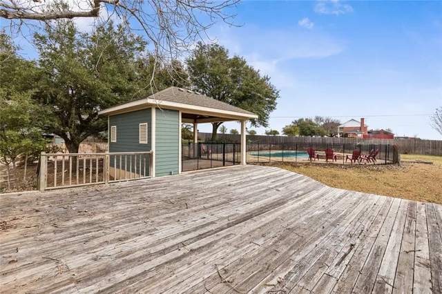 a view of a house with a wooden deck