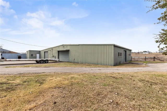 a house view with swimming pool in front of it