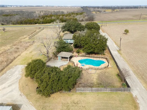a view of a swimming pool with an outdoor seating and a lake view