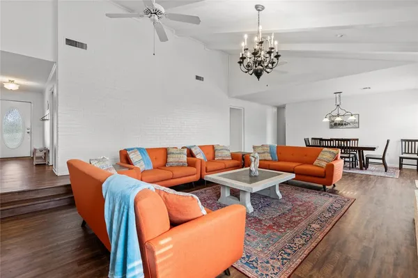 a living room with furniture and a chandelier