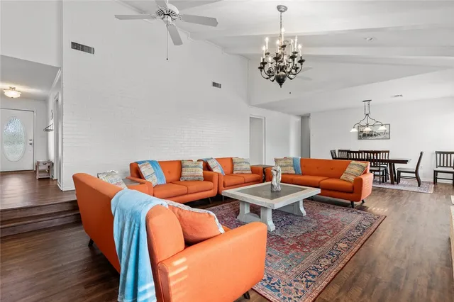 a living room with furniture and a chandelier