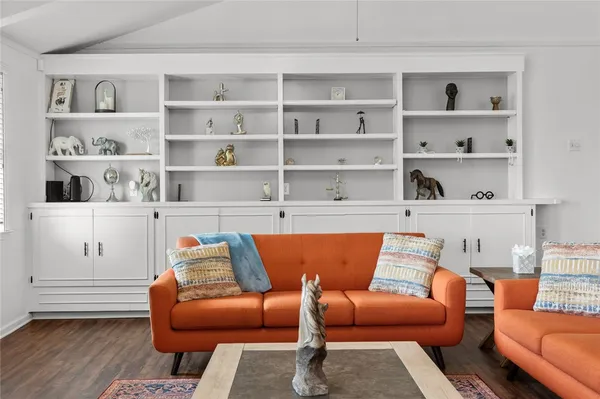 a blue couch sitting in a living room with a rug