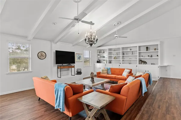 a living room with furniture flat screen tv and a fireplace