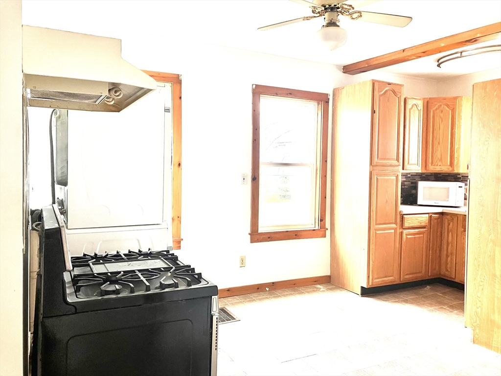 4 Sisson Terrace, Unit 1 Lynn, MA 01902 - Photo 8 of 16 a kitchen with a stove and a refrigerator