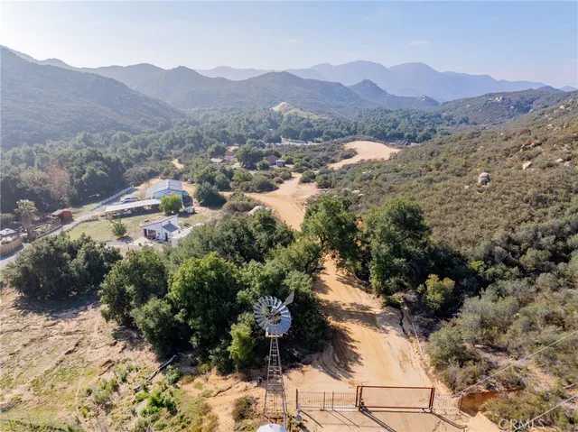 a view of a backyard with large trees