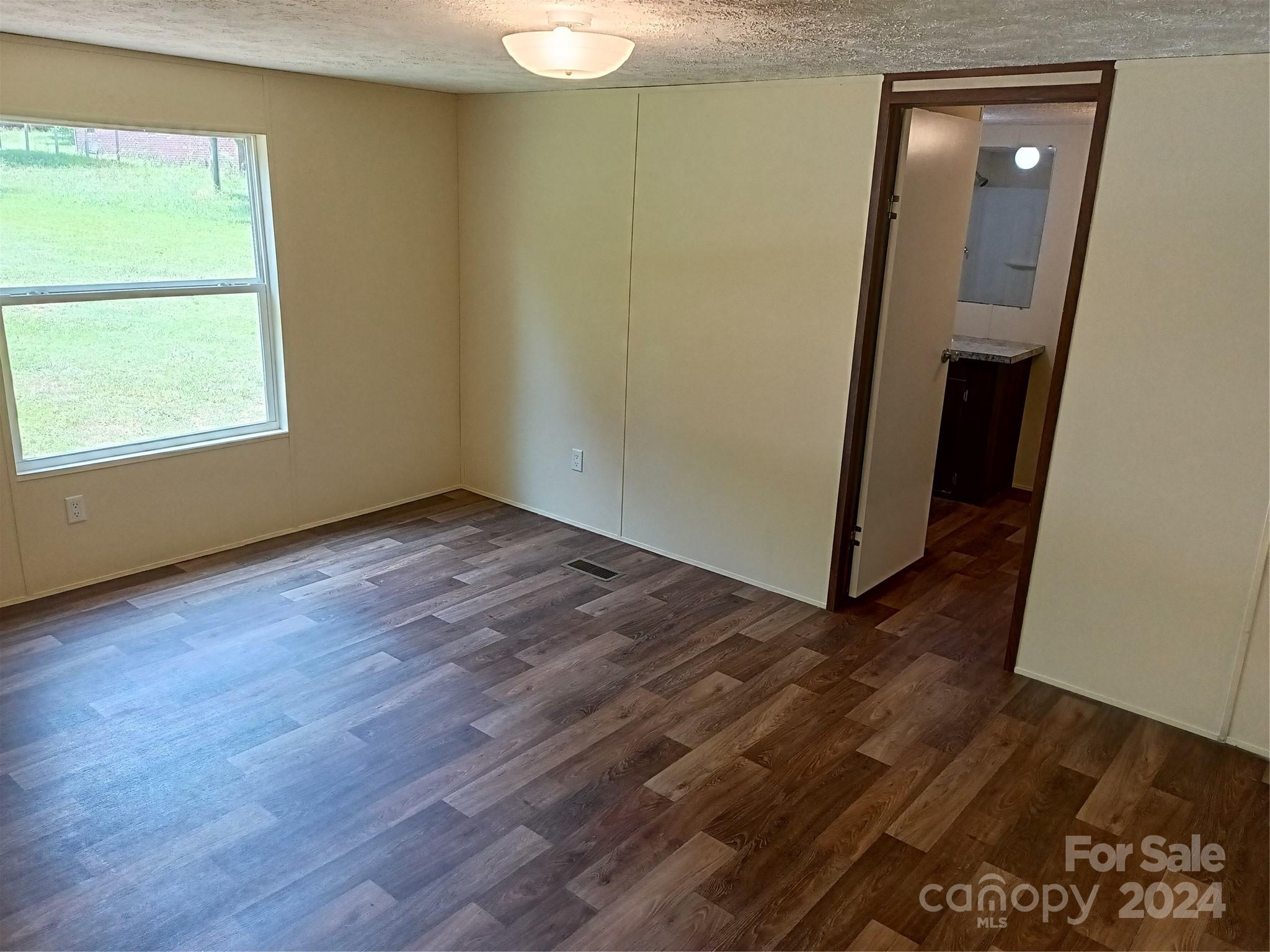 850 Butler Lake Road Chester, SC 29706 - Photo 13 of 20 an empty room with wooden floor and entrance