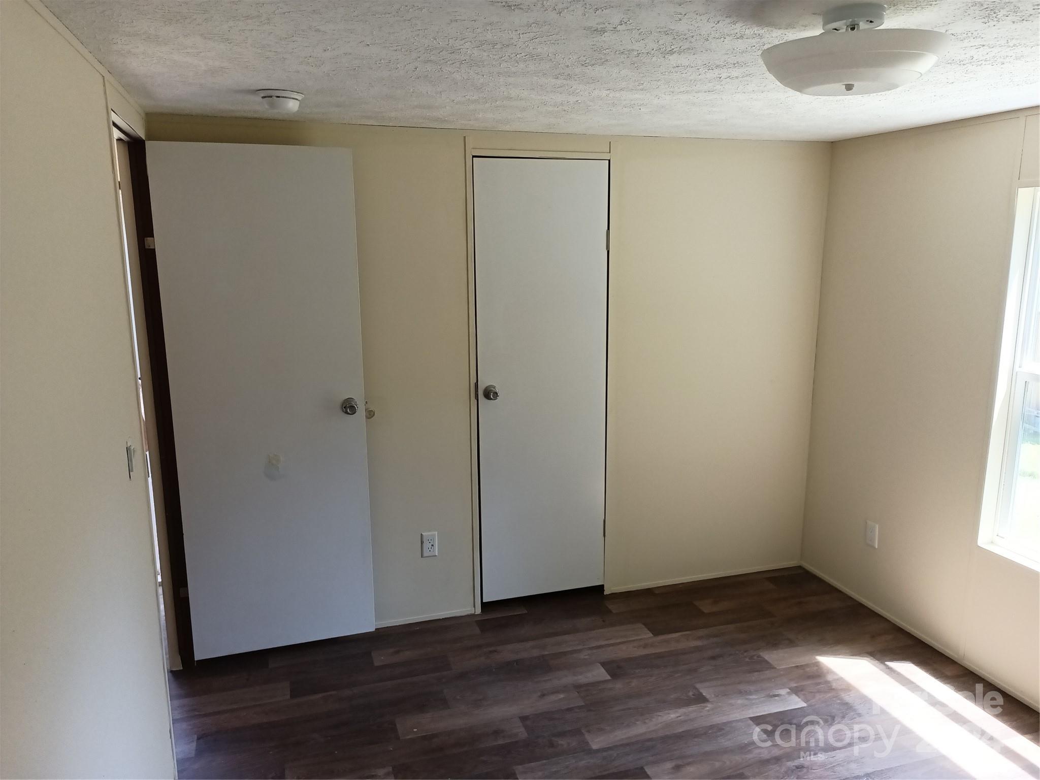 850 Butler Lake Road Chester, SC 29706 - Photo 20 of 20 a view of an empty room with wooden floor and a window