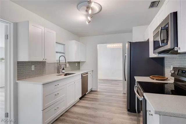 a kitchen with a sink stove and cabinets