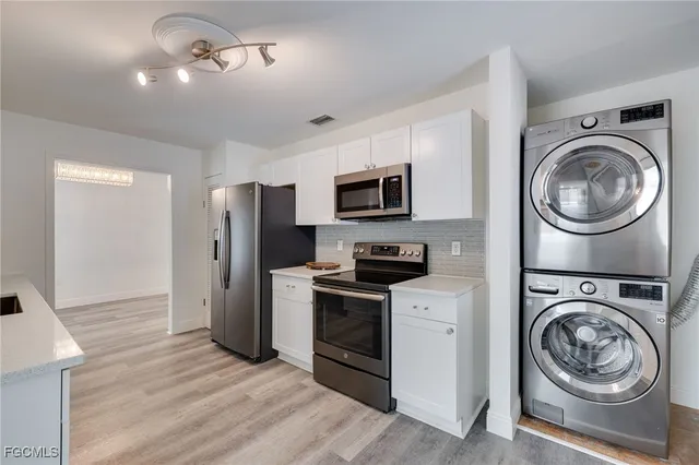 a utility room with sink dryer and washer