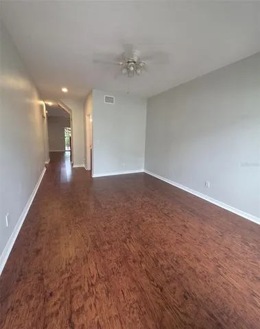 a view of a hallway with a chandelier fan