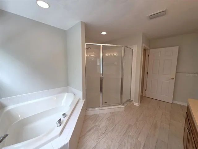 a bathroom with a tub and shower
