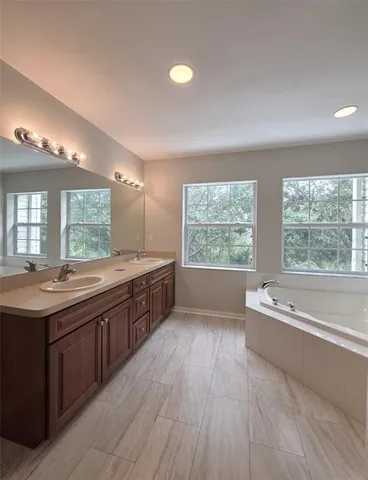 a large bathroom with a large tub and sink