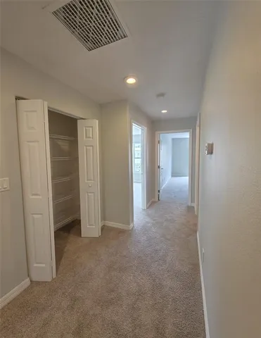 an empty room with closet and a bathroom