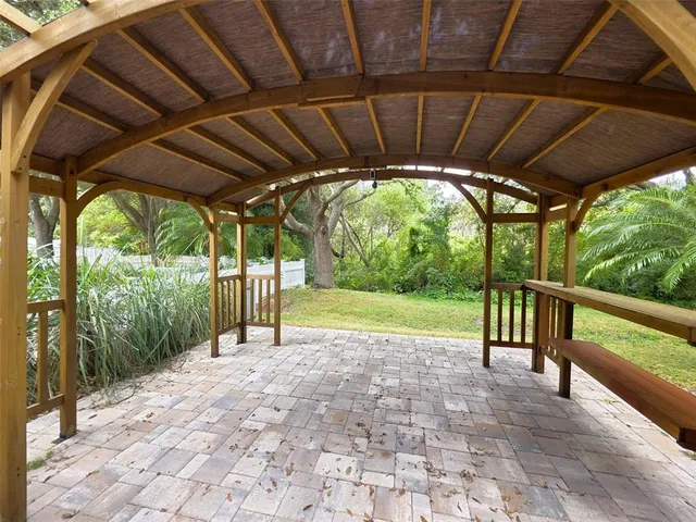 a front view of house with yard and glass top table and chairs