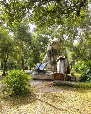 a view of a yard with large trees