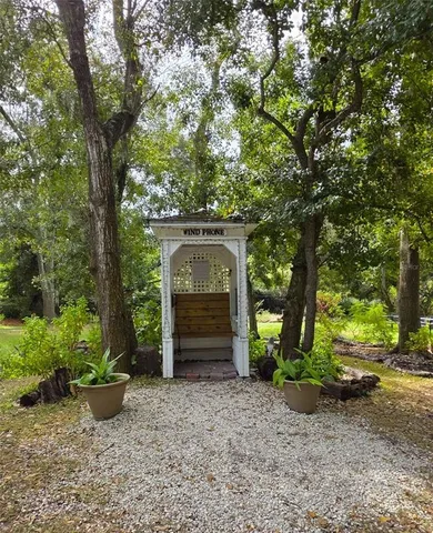 a view of a yard with wooden fence
