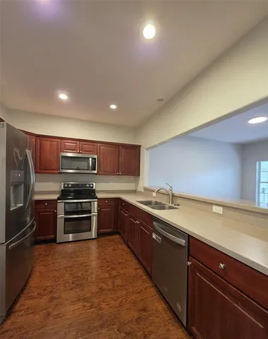 a kitchen with stainless steel appliances and a kitchen island