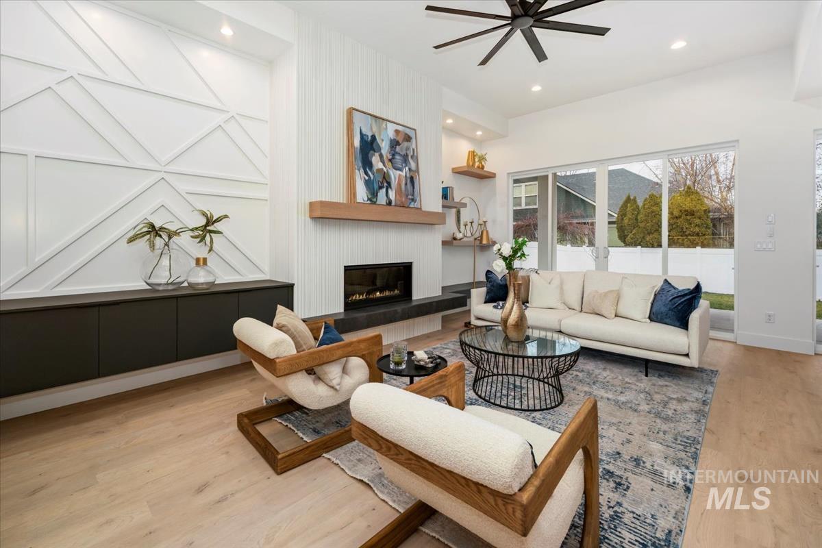 6248 West Elmer Street Boise, ID 83703 - Photo 21 of 40 Living room featuring light wood-type flooring, a large fireplace, recessed lighting, and a ceiling fan
