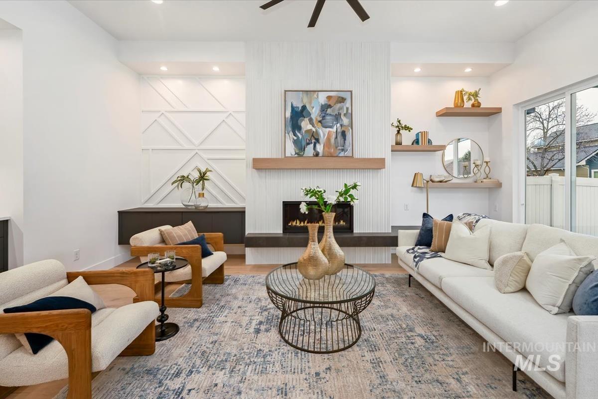 6248 West Elmer Street Boise, ID 83703 - Photo 22 of 40 Living area featuring wood finished floors, a fireplace, a ceiling fan, and recessed lighting