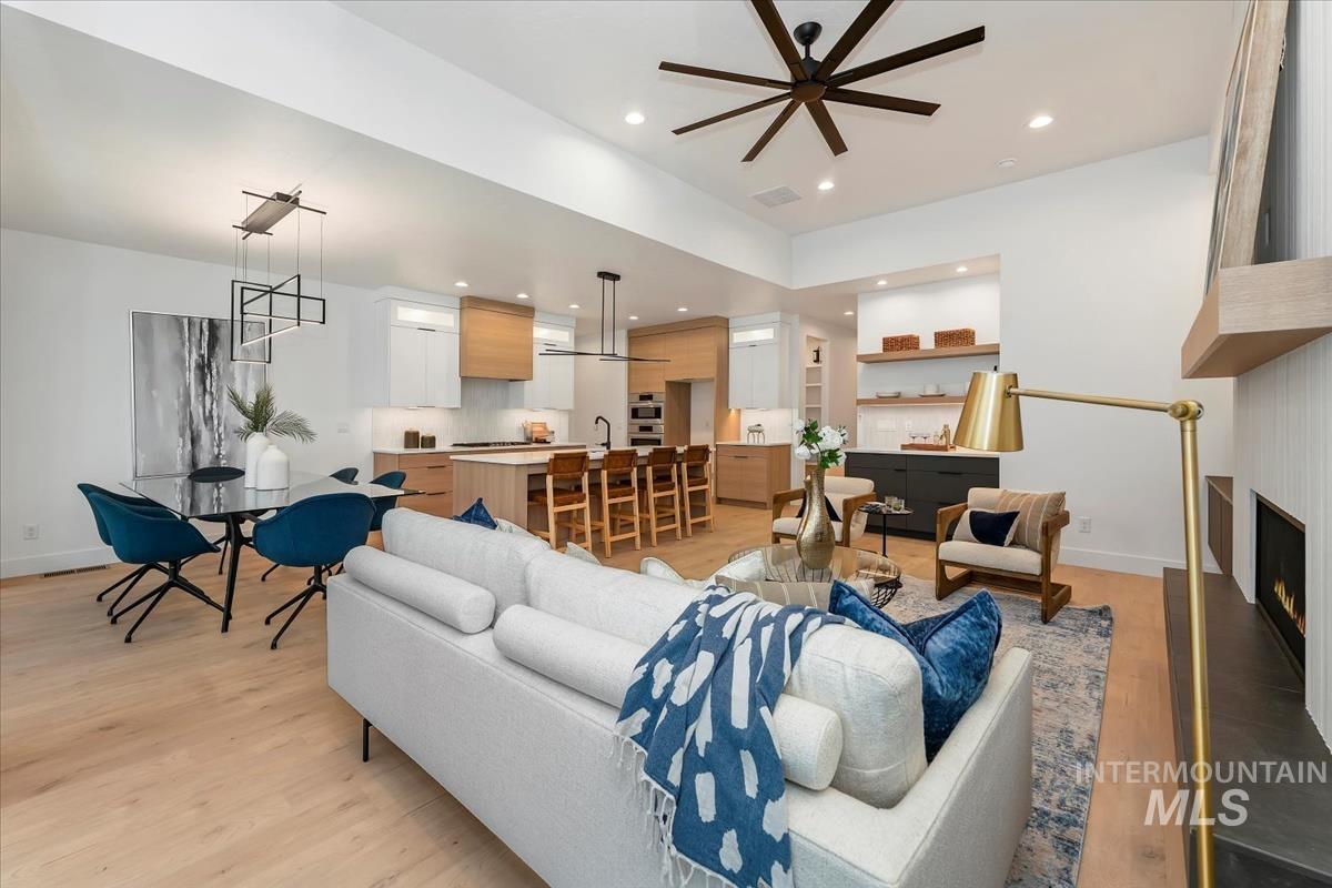 6248 West Elmer Street Boise, ID 83703 - Photo 24 of 40 Living area with light wood-style floors, a large fireplace, recessed lighting, and ceiling fan