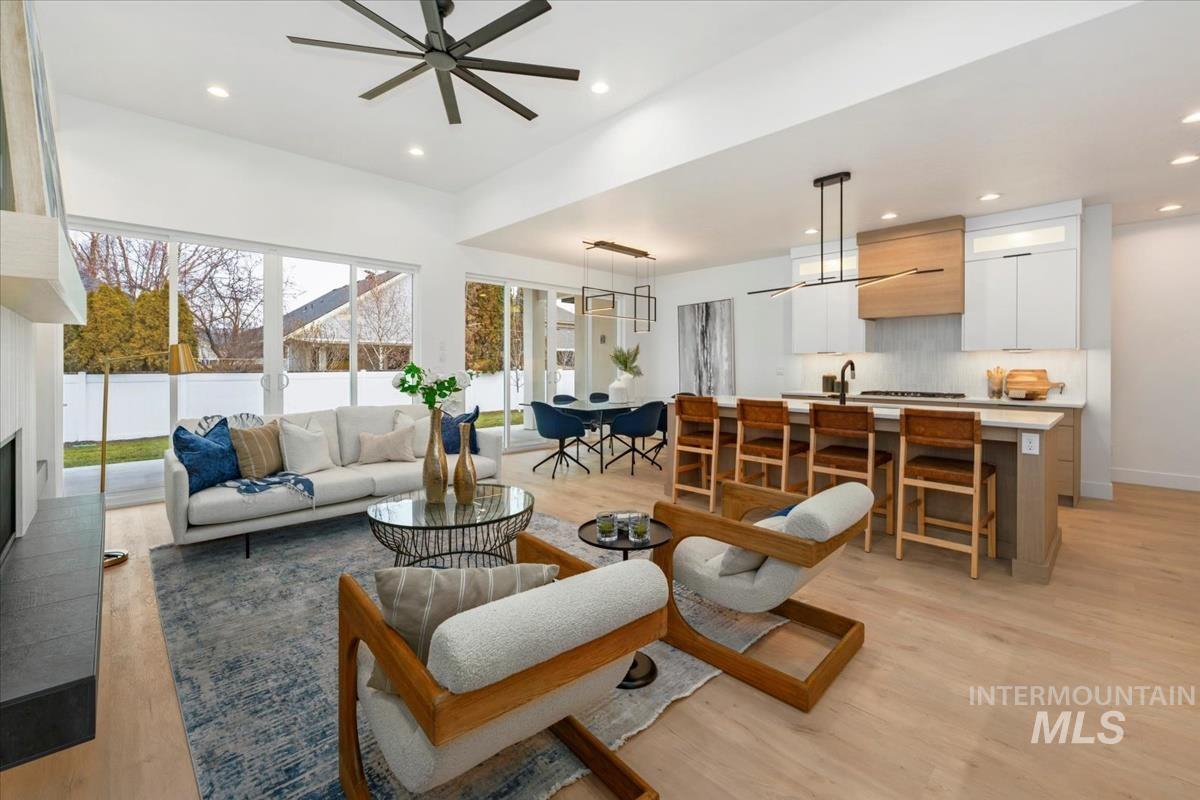 6248 West Elmer Street Boise, ID 83703 - Photo 25 of 40 Living room featuring light wood-style floors, recessed lighting, ceiling fan, and a fireplace with raised hearth