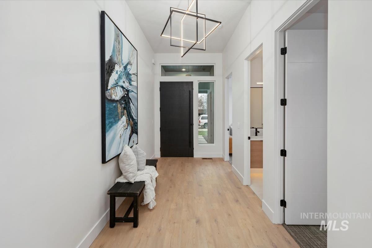 6248 West Elmer Street Boise, ID 83703 - Photo 3 of 40 Foyer entrance featuring light wood-style flooring and a chandelier