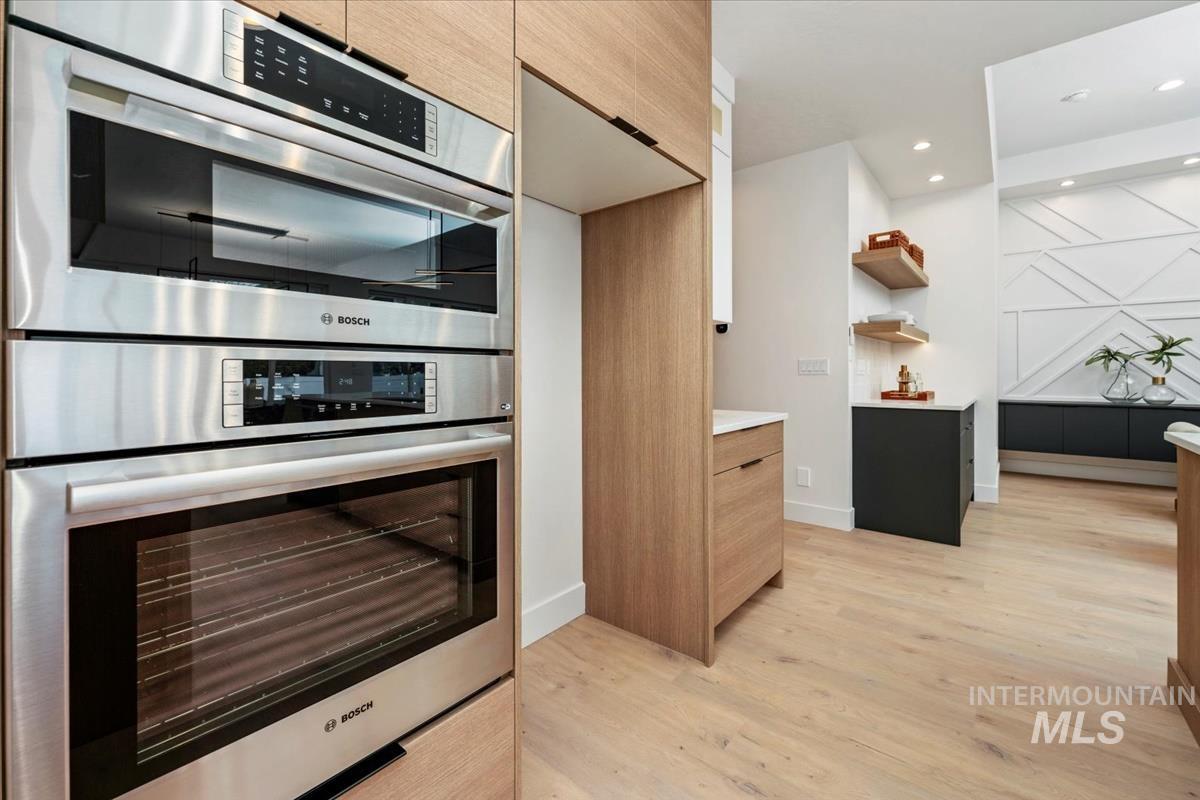 6248 West Elmer Street Boise, ID 83703 - Photo 30 of 40 Kitchen with stainless steel double oven, modern cabinets, light wood-type flooring, recessed lighting, and brown cabinetry