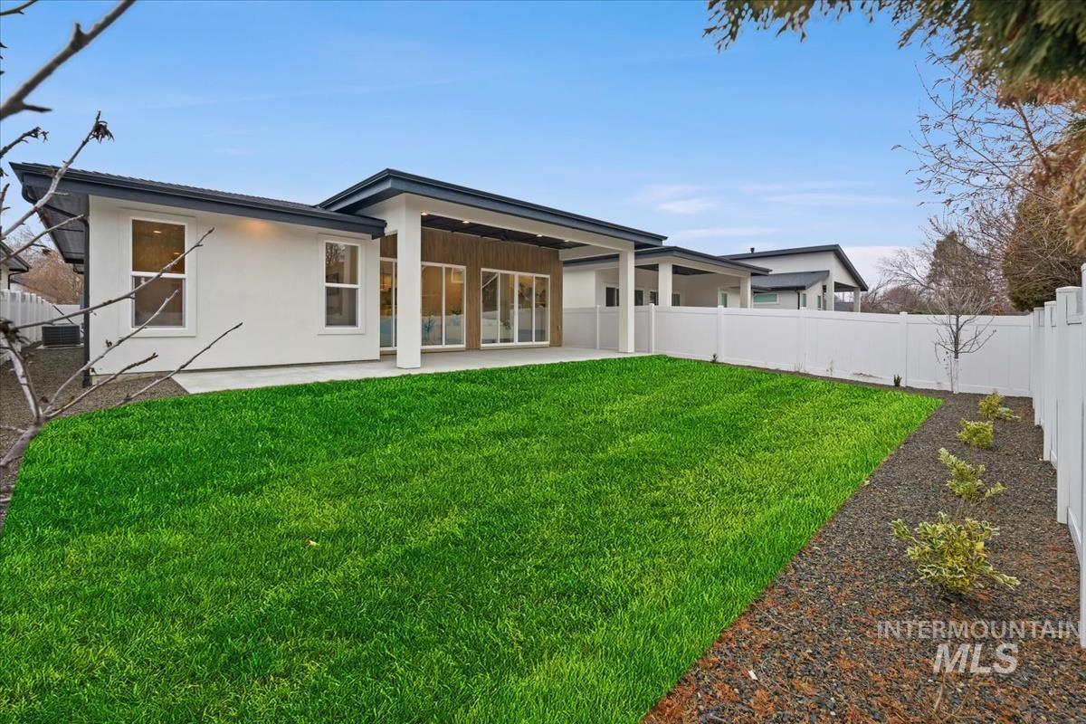 6248 West Elmer Street Boise, ID 83703 - Photo 38 of 40 Back of house with a fenced backyard, a patio area, and stucco siding