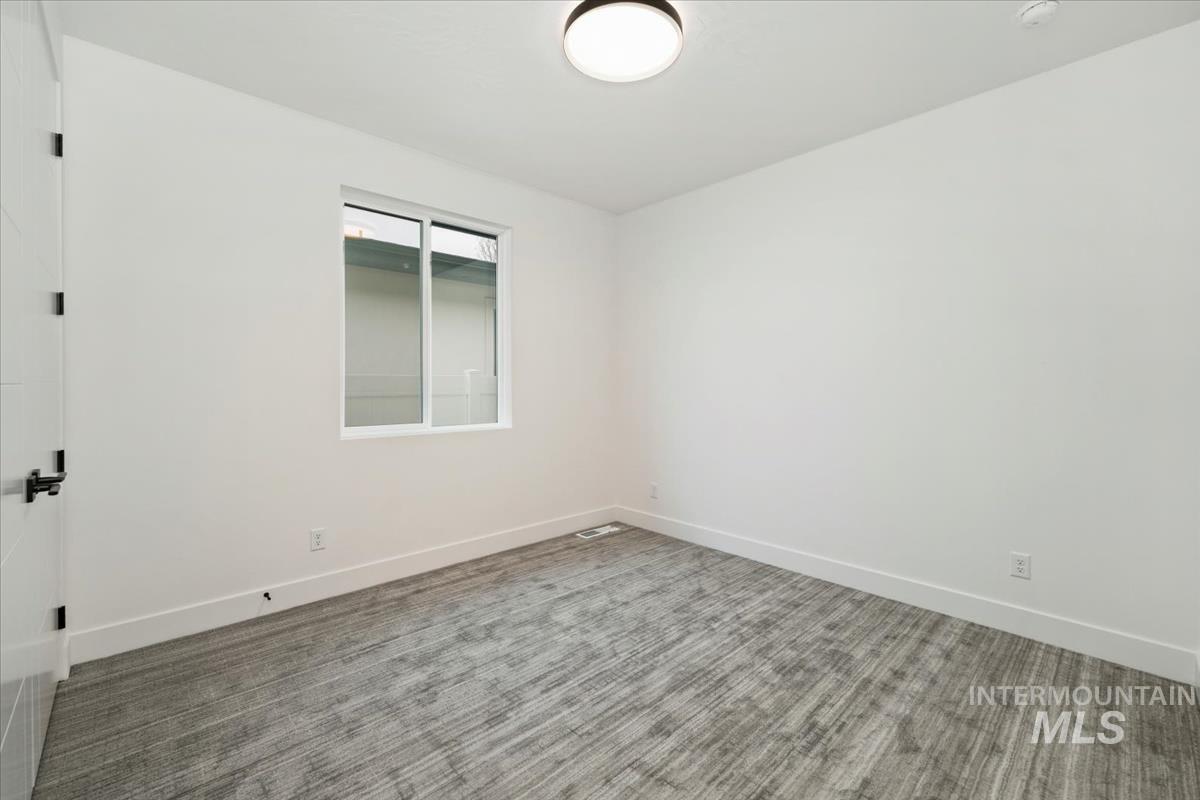 6248 West Elmer Street Boise, ID 83703 - Photo 6 of 40 Carpeted spare room featuring baseboards