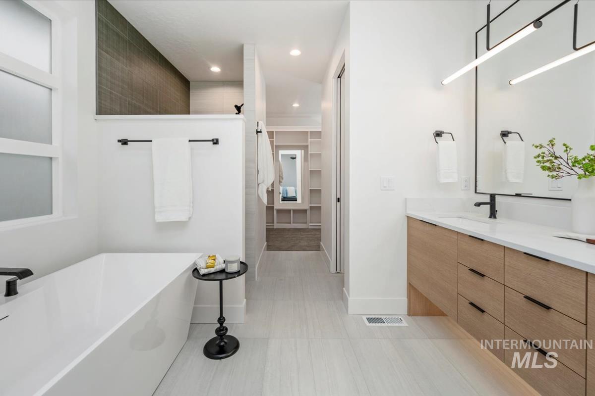 6248 West Elmer Street Boise, ID 83703 - Photo 10 of 40 Full bath with a walk in closet, vanity, a soaking tub, recessed lighting, and walk in shower