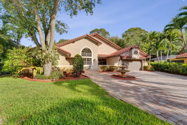 a view of a house with backyard porch and sitting area