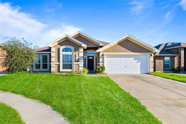 a front view of a house with a yard and garage