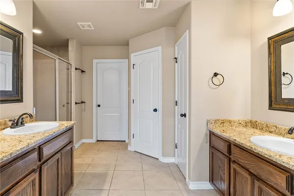 a spacious bathroom with a granite countertop sink a mirror and a