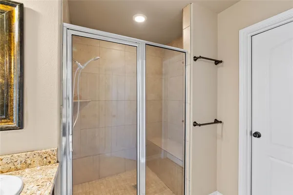 a bathroom with a glass shower door